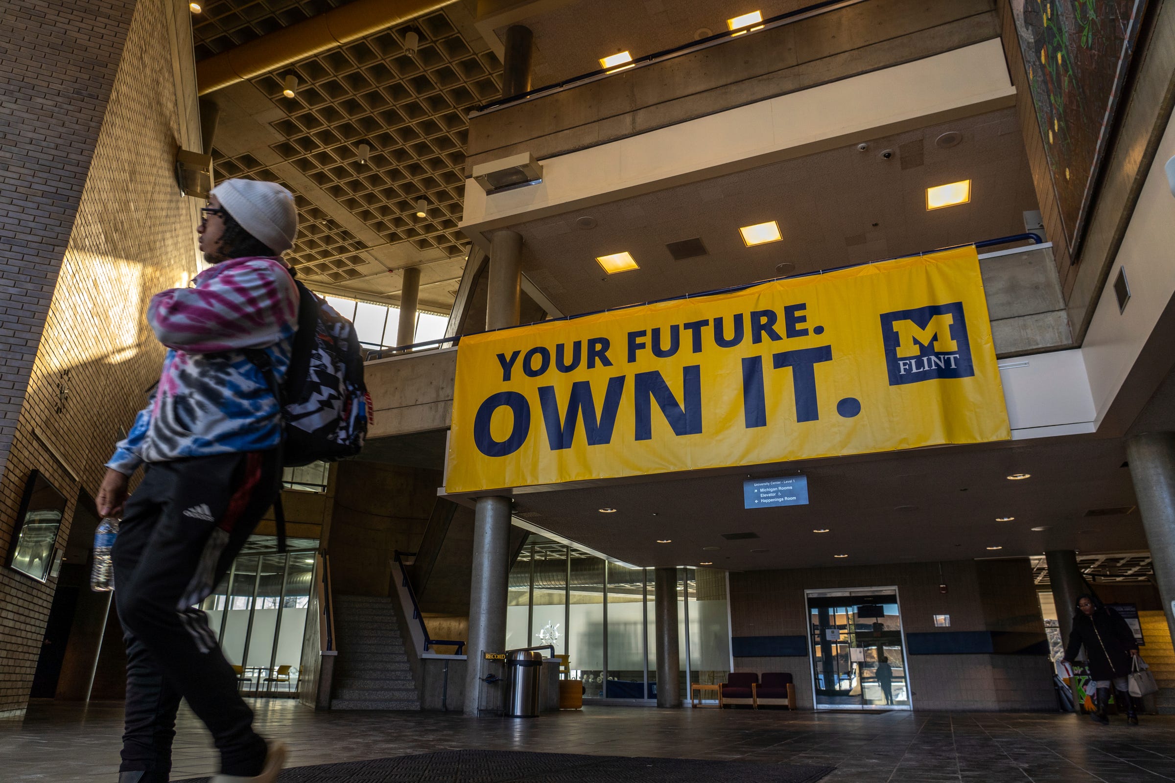 Students walk through the Harding Mott University Center at the U-M Flint campus in downtown Flint on Wednesday, Feb. 1, 2023.