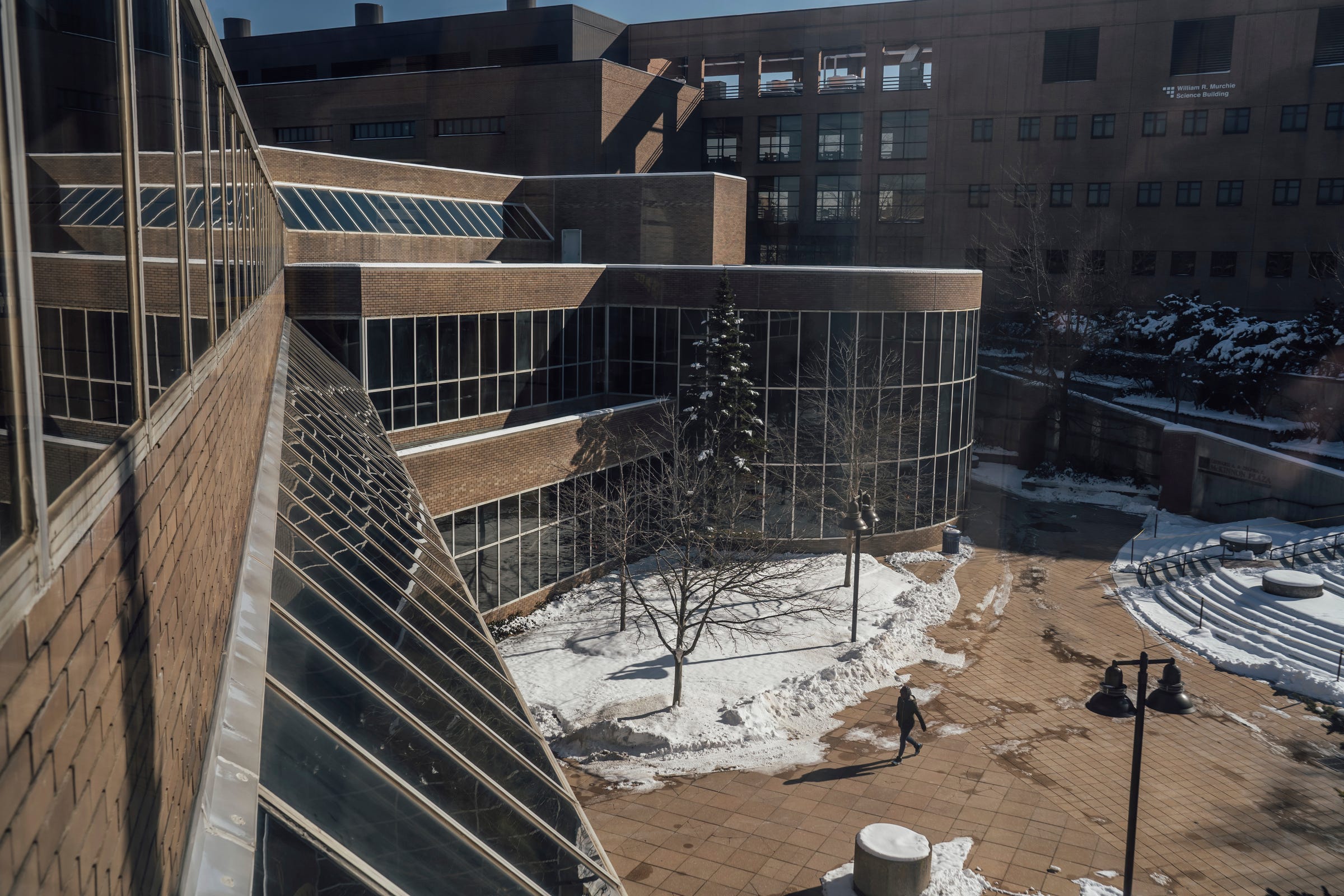 A woman walks through the U-M Flint campus in downtown Flint on Wednesday, Feb. 1, 2023, toward the Harding Mott University Center.