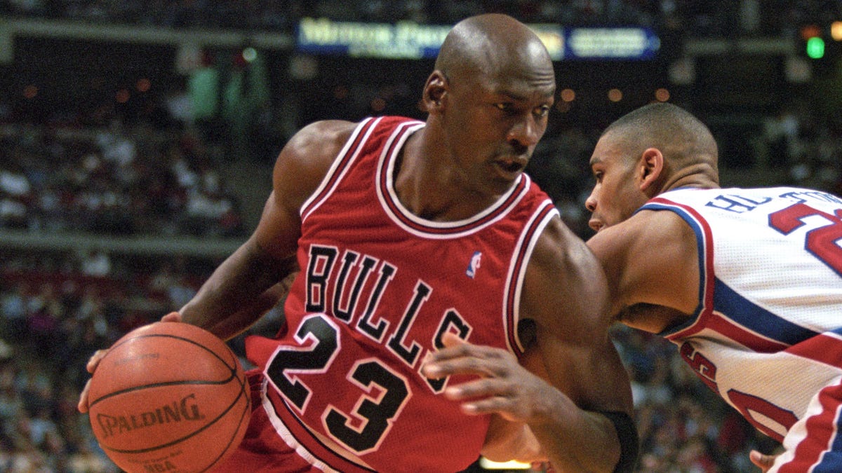 Chicago Bulls guard Michael Jordan in action against Detroit Pistons guard Allan Houston at the Palace at Auburn Hills, Feb. 15, 1996. The Bulls beat the Pistons 112-109 in overtime.