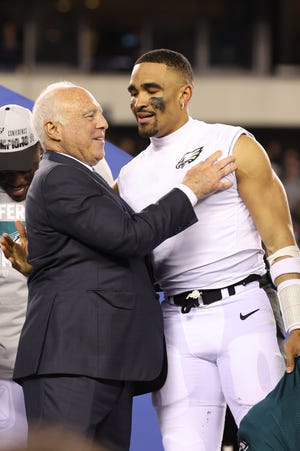 Philadelphia Eagles owner Jeffrey Lurie and quarterback Jalen Hurts (1) during the NFC championship trophy presentation after a win against the San Francisco 49ers.