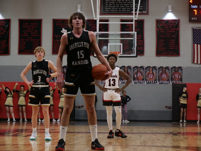 Amarillo High's Braden Hausen (15) prepares to shoot a free throw as his teammate Will Williams (3) and Tascosa's Aushaun Wilson (13) wait for play to resume on Friday, February 3, 2023 at Tascosa High School.