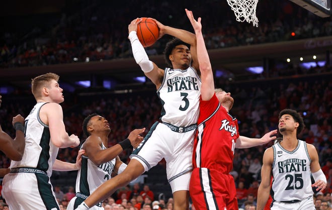 Michigan State guard Jaden Akins (3) grabs a rebound against Rutgers guard Cam Spencer (10) during the first half of an NCAA college basketball game in New York, Saturday, Feb. 4, 2023. (AP Photo/Noah K. Murray)