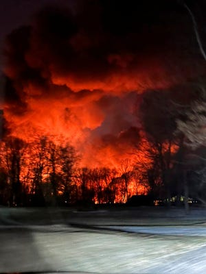 A train fire is seen from Melissa Smith's farm in East Palestine, Ohio earlier this month. A train derailment and resulting large fire prompted an evacuation order in the Ohio village near the Pennsylvania state line.