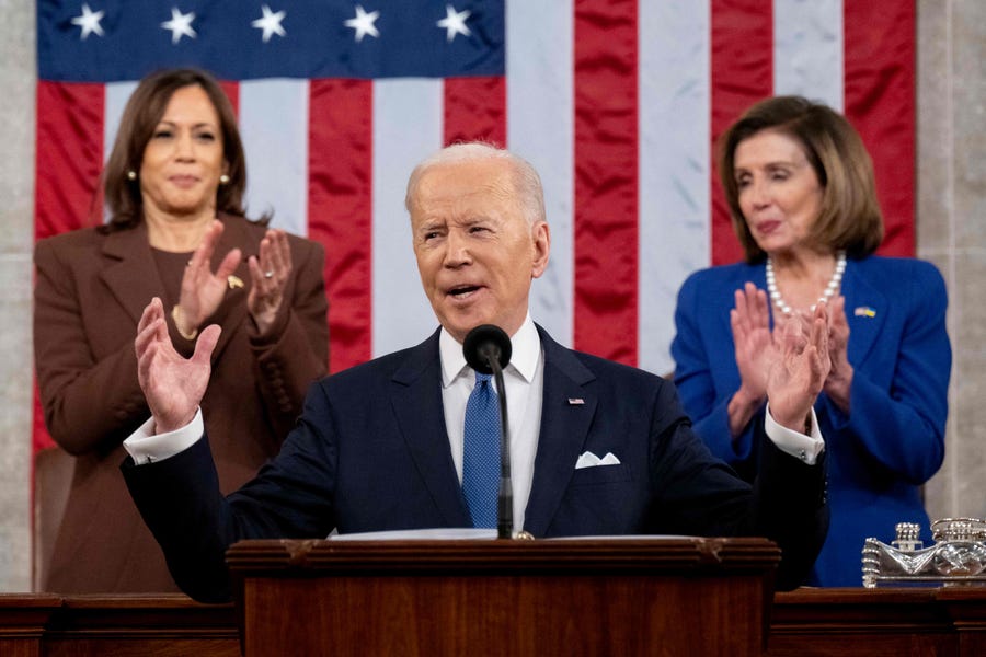TOPSHOT - US Vice President Kamala Harris (L) and US House Speaker Nancy Pelosi (D-CA) applaud US President Joe Biden as he delivers his first State of the Union address at the US Capitol in Washington, DC, on March 1, 2022.