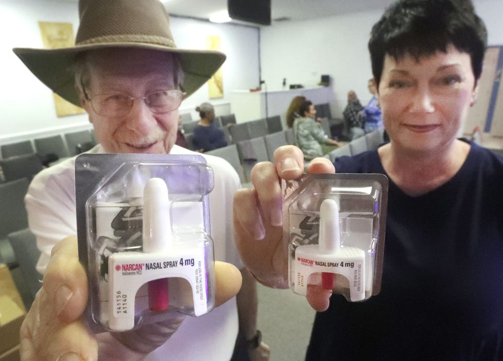 Michael Feldbauer, president of the Flagler County Drug Court Foundation, and Reneé DeAngelis, the Narcan administrator, hold packages of Narcan nasal spray, which reverses opioid overdoses, Saturday, Feb. 4, 2023, before the start of a training session at Iglesia Pentecostal Ebenezer de Bunnell Church.