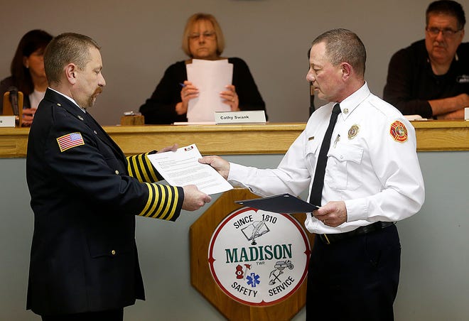 Madison Township Fire Chief Ken Justus, left, receives his Ohio Fire Chiefs' Association certification from City of Ashland Fire Chief Rick Anderson at the Monday township trustee meeting. Justus is one of 66 fire active chiefs to obtain this certification.