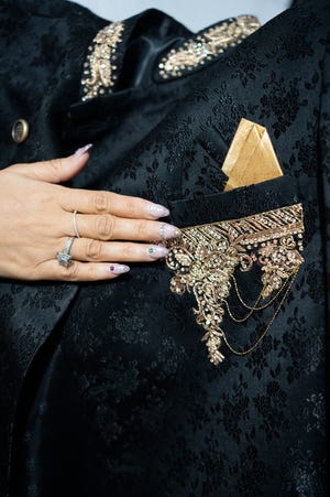 Anjali Phougat shows off a men’s black sequin sherwani coat, embroidered with golden wire using a traditional Indian technique called zardozi.