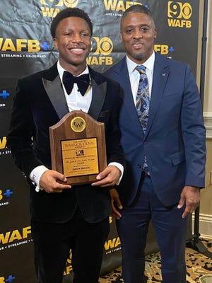 Calvin Delone of Ascension Catholic High School is shown with former NFL player Warrick Dunn.