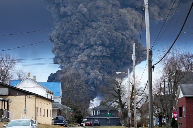 A black plume rises over East Palestine, Ohio, as a result of a controlled detonation of a portion of the derailed Norfolk and Southern trains Monday, Feb. 6, 2023. (AP Photo/Gene J. Puskar)