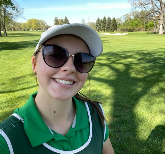 Lauren Haring, a Lakeland High School senior, caddies at Pine Lake Country Club in West Bloomfield Township.