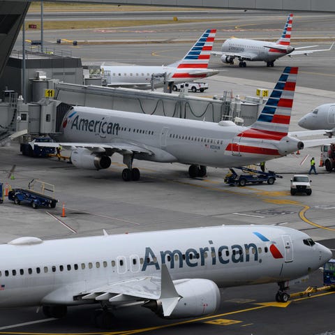 American Airlines airplanes sit on the tarmac at L