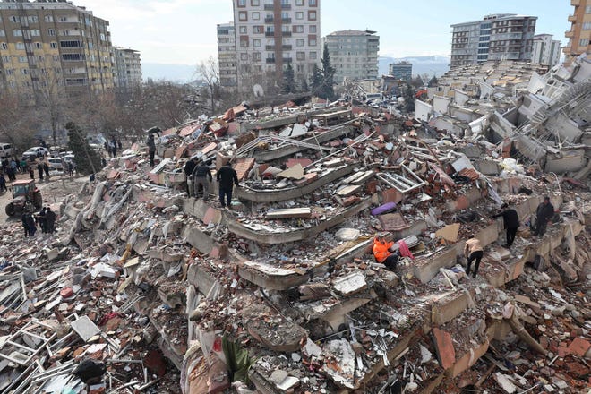 Civilians look for survivors under the rubble of collapsed buildings in Kahramanmaras, Turkey, close to the quake's epicenter, the day after a 7.8-magnitude earthquake struck the country's southeast, on Tuesday.