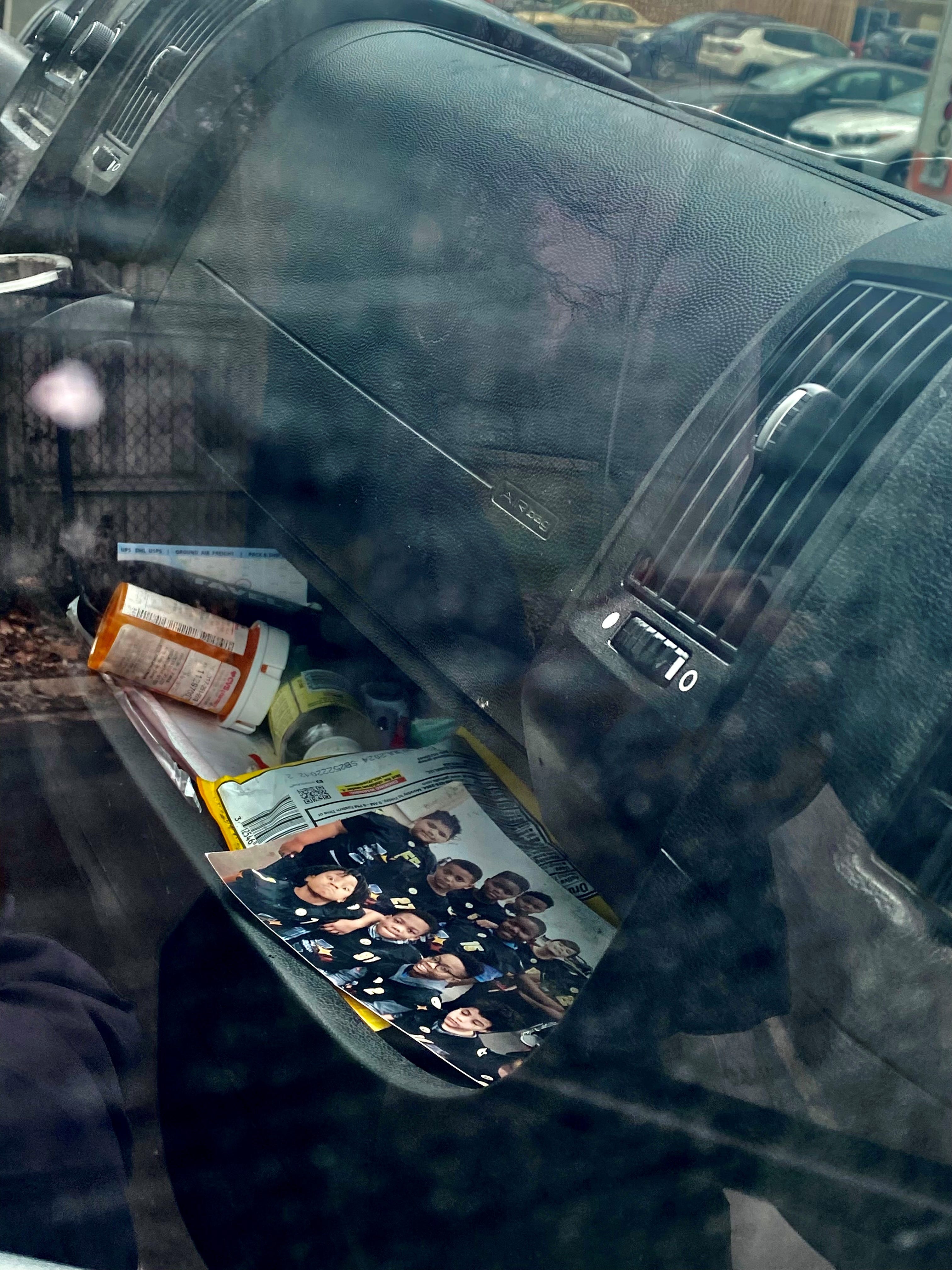 A photo of the Indy Steelers sits in the console of the van where coach Richard Donnell Hamilton died. Coach Nell, as he was known to members of the youth football program, was shot while riding in the passenger seat during a road rage incident on Jan. 11, 2023, according to Indiana State Police.