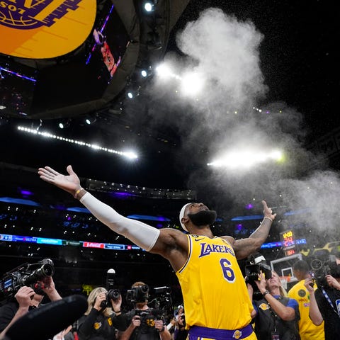 Lakers forward LeBron James tosses powder in the a