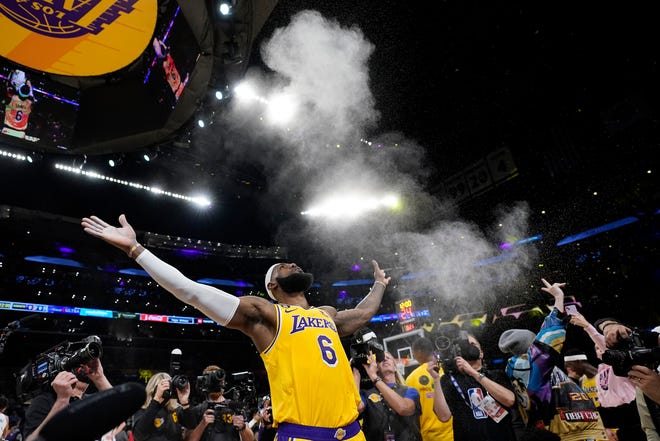 Lakers forward LeBron James tosses powder in the air prior to the team's game against the Oklahoma City Thunder on Tuesday, Feb. 7, 2023, in Los Angeles.