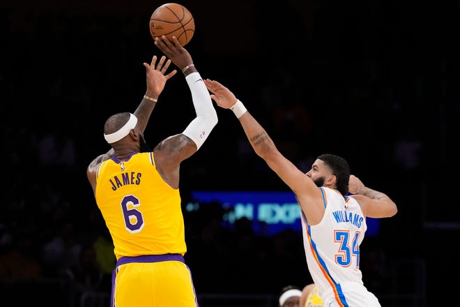 Lakers forward LeBron James, left, shoots as Oklahoma City Thunder forward Kenrich Williams defends during the first half Tuesday, Feb. 7, 2023, in Los Angeles.