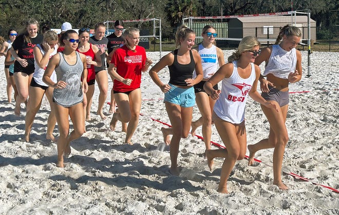 Players take the court for the Cardinal Mooney Catholic High beach volleyball team. The Cougars will play on their own home courts this season.