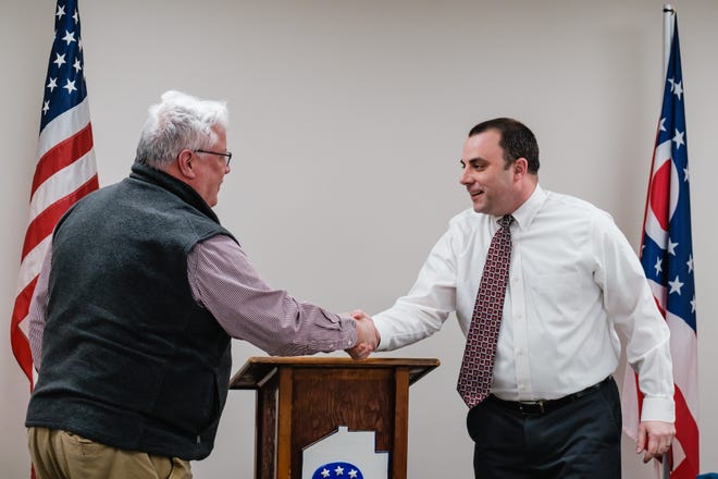 New Philadelphia Mayor Joel Day, left, shakes the hand of Shane Gunnoe after Gunnoe is renamed as mayor of Dover by the Tuscarawas County Republican Central Committee. He replaces Interim Mayor Justin Perkowski,