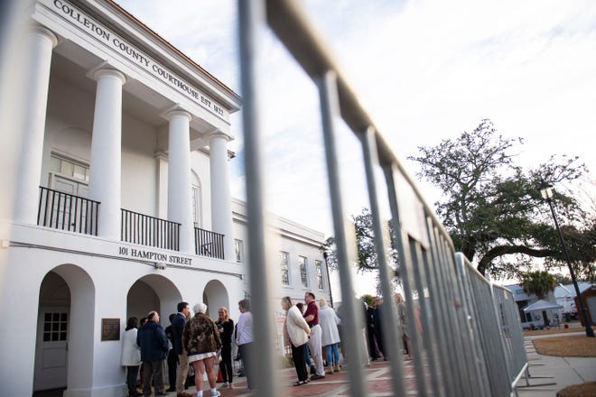 Members of the public wait to be let into the Colleton County Courthouse to watch day 13 of Alex Murdaugh's double murder trial in Walterboro, S.C., on Wednesday, Feb. 8, 2023. 
