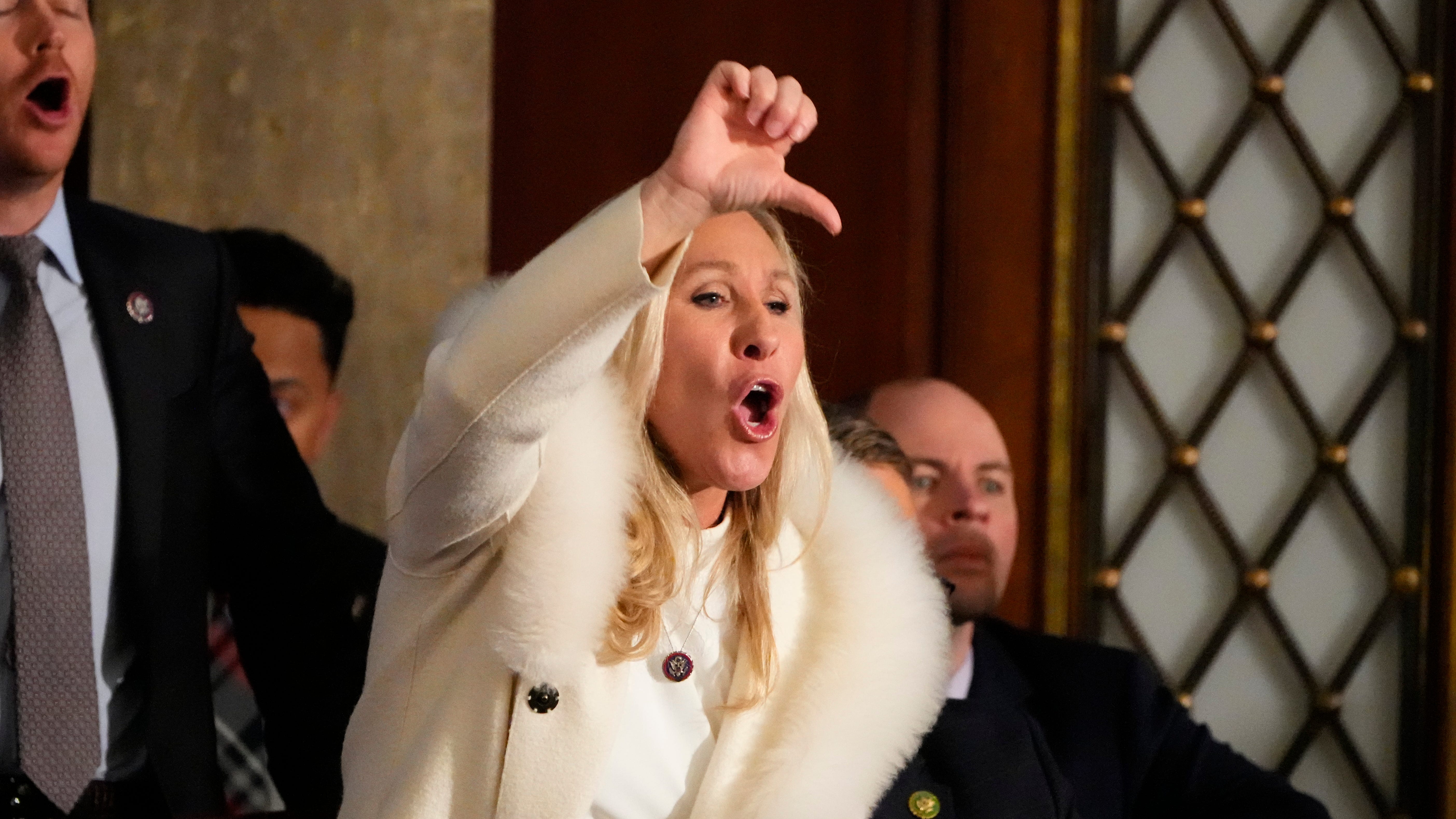 Rep. Marjorie Taylor Greene, R-GA, yells in the chambers as President Joe Biden speaks during the State of the Union address from the House chamber of the United States Capitol in Washington.
