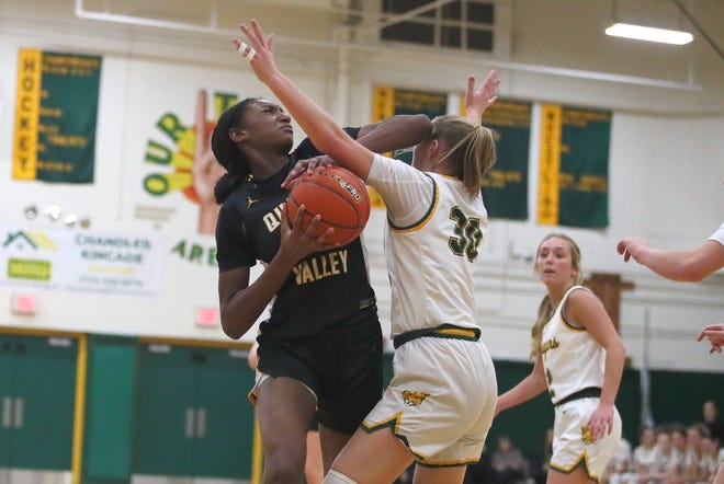 Quaker Valley's Oumou Thiero (2) fights past Blackhawk's Piper Romigh (30) while attempting a layup during the second half Wednesday night at Blackhawk High School.