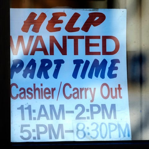 A help wanted sign is displayed at a restaurant in