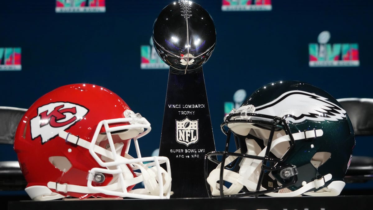 Kansas City Chiefs and Philadelphia Eagles helmets sit next to the Vince Lombardi Trophy.