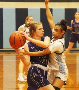 Prairie Central's Marissa Collins applies defensive pressure on Abriel Smith of El Paso-Gridley Thursday. Collins helped the Hawks to a 60-37 win.