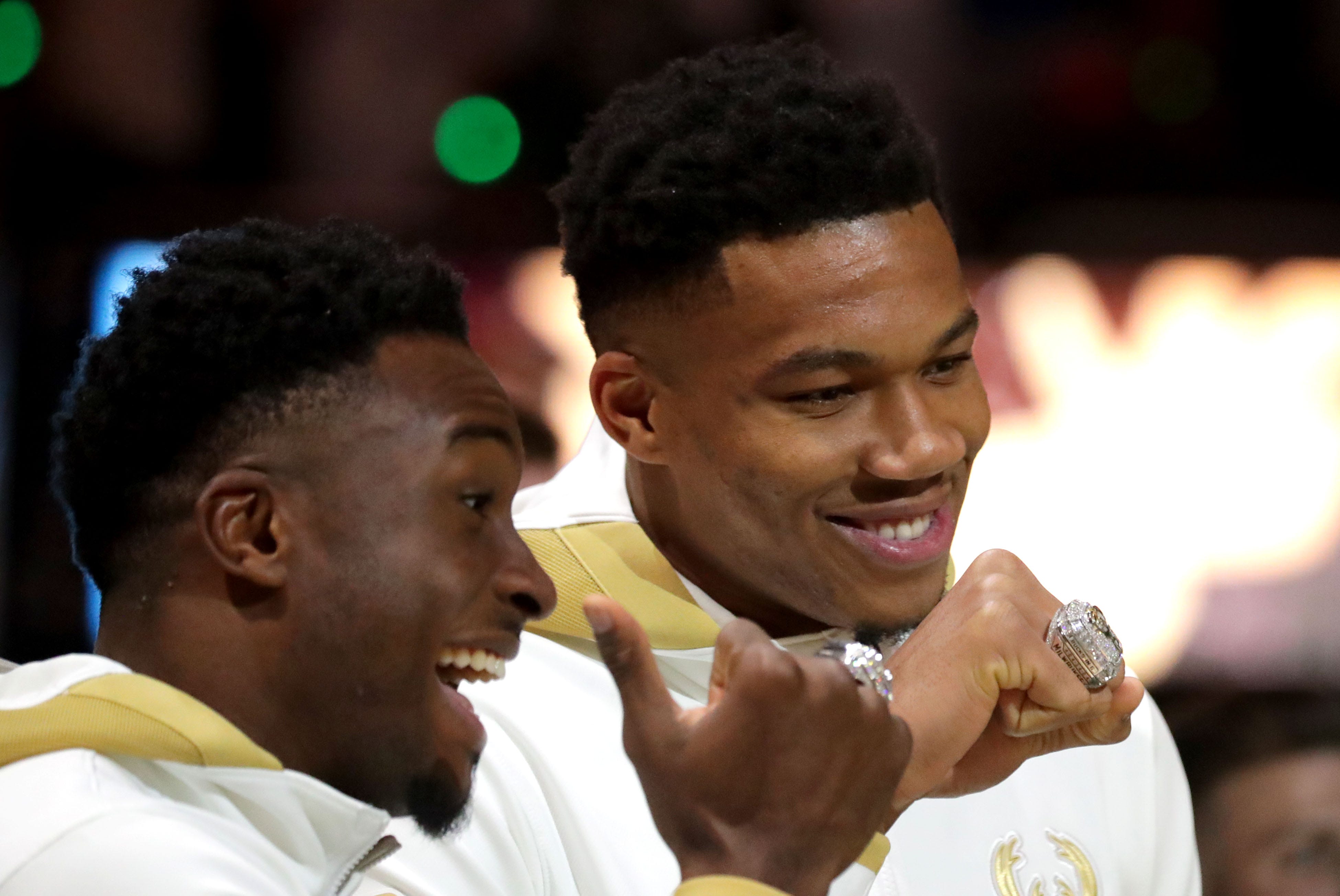Giannis Antetokounmpo, right, and older brother Thanasis show off their NBA championship rings before the 2021-22 season opener.