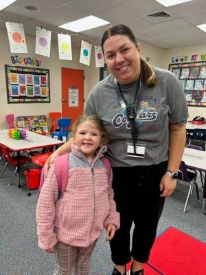 Everlee and her teacher, Mrs. Beck, pose for a photo.