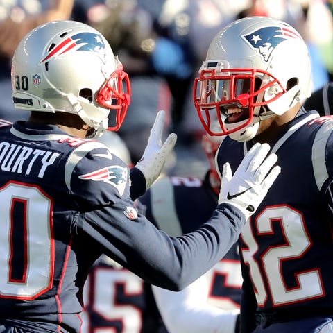 Jason McCourty, left, and Devin McCourty react dur