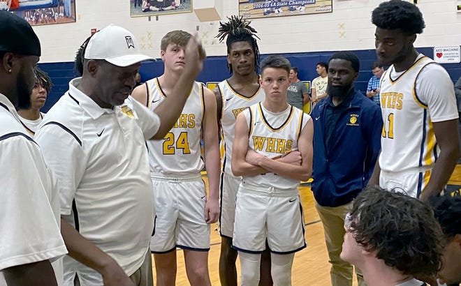 Winter Haven coach Tyrone Woodside (white cap) talks to his players during a time out against Plant City on Friday night.