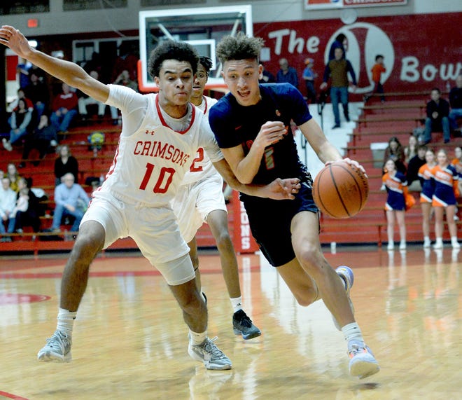 Rochester's Darrias Christmon drives past Jacksonville's Zaidyn Jefferies during the gameFriday. Feb. 10, 2023.