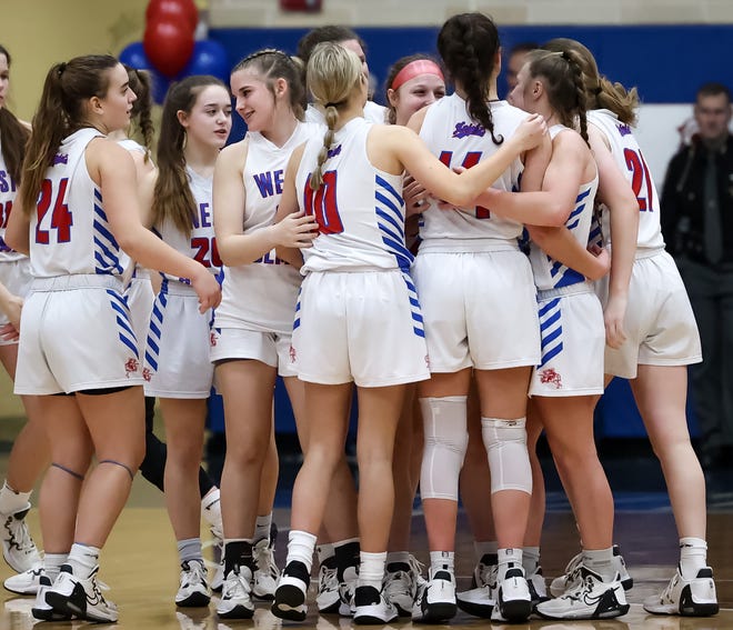 West Holmes celebrates an overtime win over rival Triway on Senior Night honoring senior Ella McMillen (14).