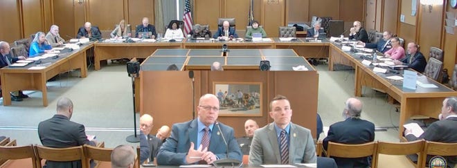 John Scippa (left), director of the New Hampshire Police Standards and Training Council, and Capt. Adam Hawkins, who oversees fitness testing for the council, answer lawmakers’ questions about a bill that would eliminate the test for law enforcement officers.