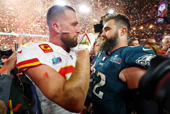 Kansas City Chiefs tight end Travis Kelce (87) talks with his brother, Philadelphia Eagles center Jason Kelce (62), after the Super Bowl.