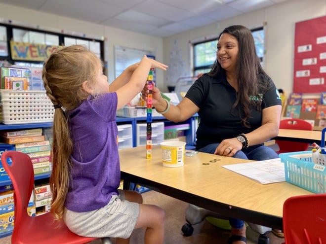 Natalia Sandoval, a special education teachers at Waikiki Elementary School in Hawaii, does an activity with a student. Hawaii, like most states, suffers from a shortage of special education teachers.