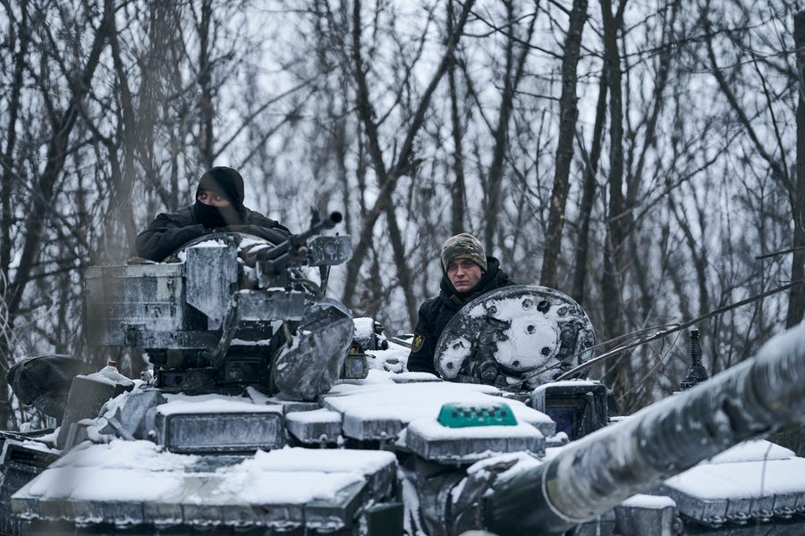 A Ukrainian tank rides to its position in the frontline in Bakhmut, Donetsk region, Ukraine, Sunday, Feb. 12, 2023.