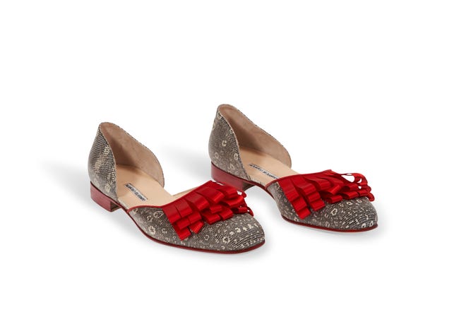 A pair of reptile skin and red silk-embellished Manolo Blahnik evening shoes from André Leon Talley's collection.