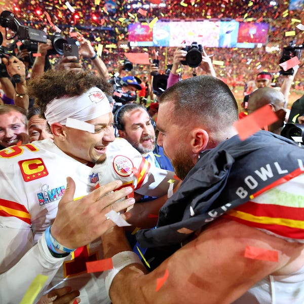 Kansas City Chiefs quarterback Patrick Mahomes (left) celebrates with tight end Travis Kelce (right) after winning Super Bowl 57.