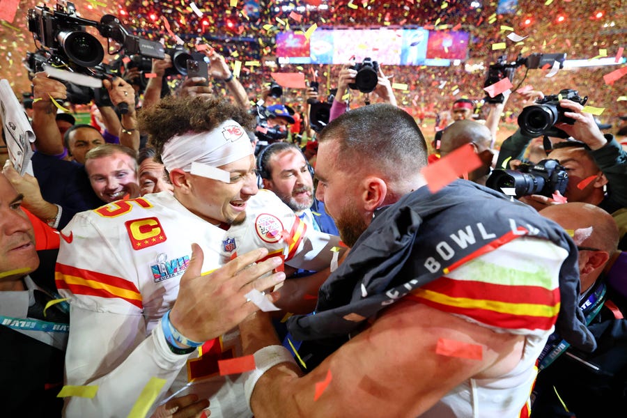 Kansas City Chiefs quarterback Patrick Mahomes (left) celebrates with tight end Travis Kelce (right) after winning Super Bowl 57.