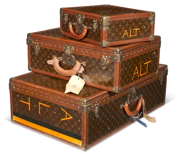 Three personalized brown monogram lacquered canvas hard-sided suitcases from Louis Vuitton from André Leon Talley's collection. The set of three sold for $94,500, according to Christie's.
