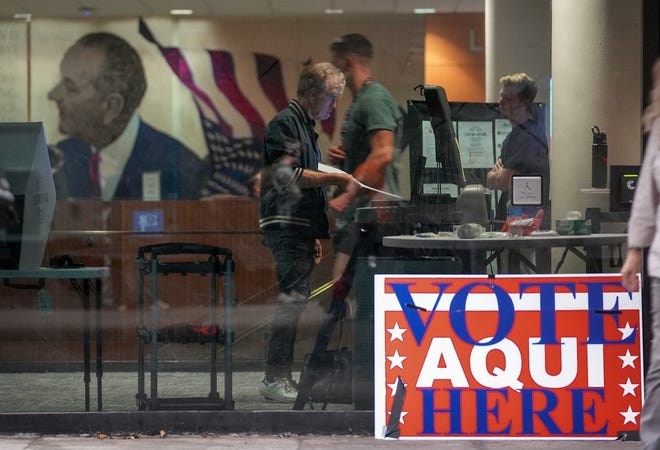 A voter is shown last year at a polling place at the University of Texas Lyndon B. Johnson School of Public Affairs. Austin voters in May will see two ballot propositions on police oversight.