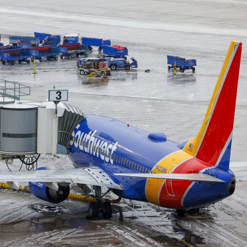 A plane with Southwest Airlines sits at one of the