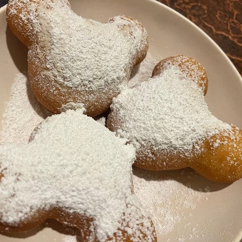 Mickey-shaped beignets are served with a choice of