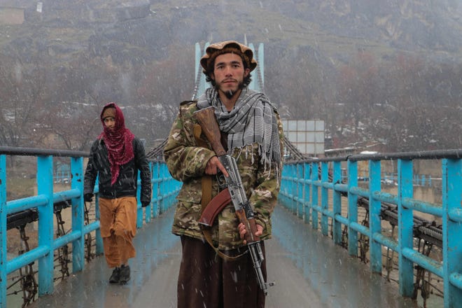 A Taliban security personnel poses for a photo along a bridge in the Fayzabad district of Badakhshan Province in Afghanistan on Feb. 13, 2023.
