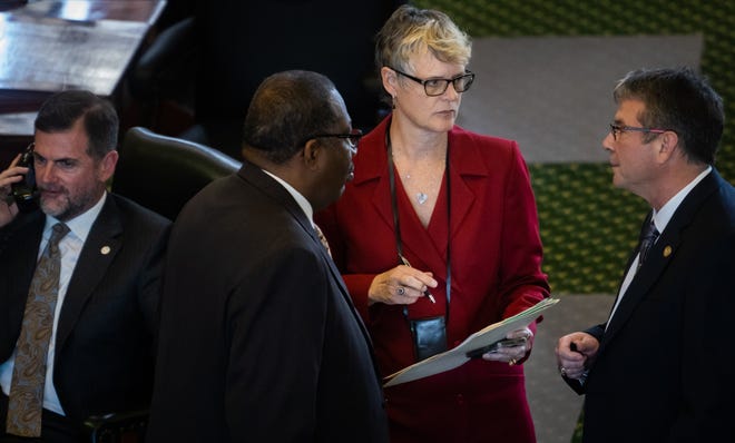 Sen. Sarah Eckhardt, center, talks with Sens. Royce West, left, and Charles Perry, right, as Sen. Brandon Creighton takes a phone call on the Texas Senate floor after a resolution she proposed to designate a Texas LGBTQ Chambers of Commerce Advocacy Day was not considered Tuesday.