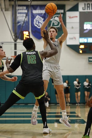 University of North Florida senior forward Carter Hendricksen (3), shooting against Jacksonville University's Mike Marsh in a Feb. 2 game, has moved into the top-five in most career statistical categories for the Ospreys.