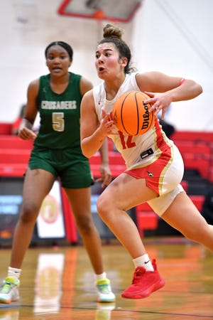 Mooney's Olivia Davis (#12) drives to the basket. Cardinal Mooney hosted Tampa Catholic in the girls basketball regional semi-final on Tuesday night. 