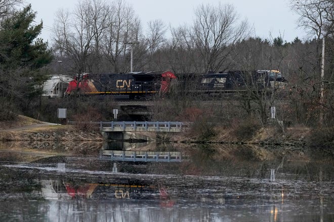 A Norfolk Southern train travels near the East Palestine City Lake in East Palestine, Ohio on Feb. 11. About 50 train cars, 11 of which carried hazardous materials, derailed in a fiery wreck on Feb. 3. A controlled release of toxic fumes was executed Feb. 6 to prevent an explosion, causing hundreds of residents to be evacuated. The mainlines of the tracks were restored to service on Feb. 7.